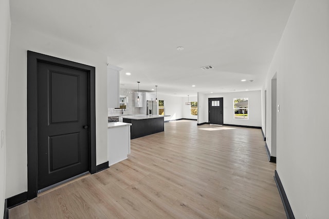 unfurnished living room featuring light hardwood / wood-style flooring