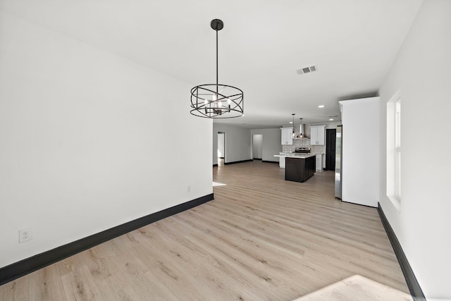 interior space featuring a chandelier and light hardwood / wood-style flooring