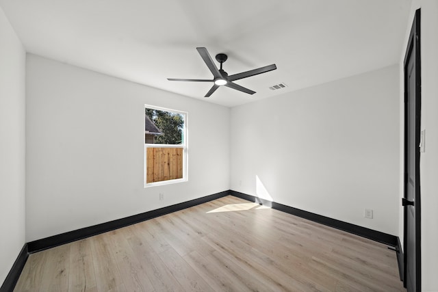 unfurnished room with light wood-type flooring and ceiling fan