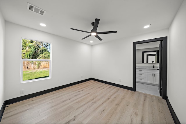 unfurnished room featuring ceiling fan, sink, and light hardwood / wood-style flooring