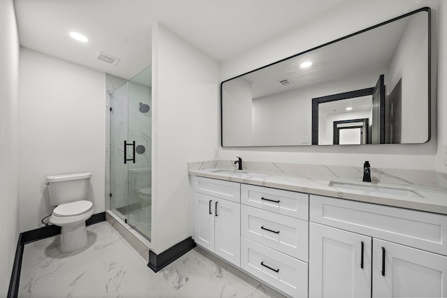 bathroom with vanity, toilet, and a shower with shower door