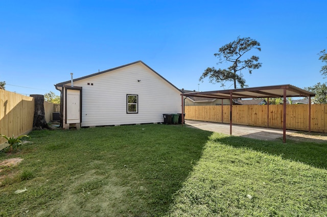 rear view of property featuring cooling unit and a lawn