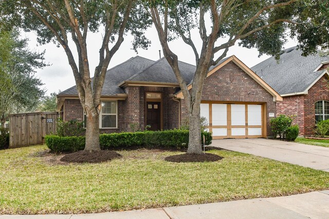 view of front facade with a garage and a front yard