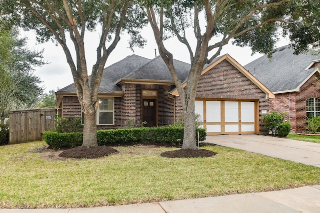 view of front of home featuring a garage and a front yard