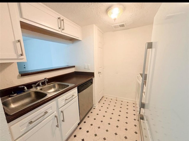 kitchen featuring dishwasher, white cabinets, a textured ceiling, and sink