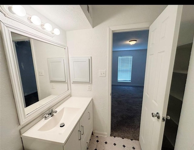 bathroom with vanity and a textured ceiling