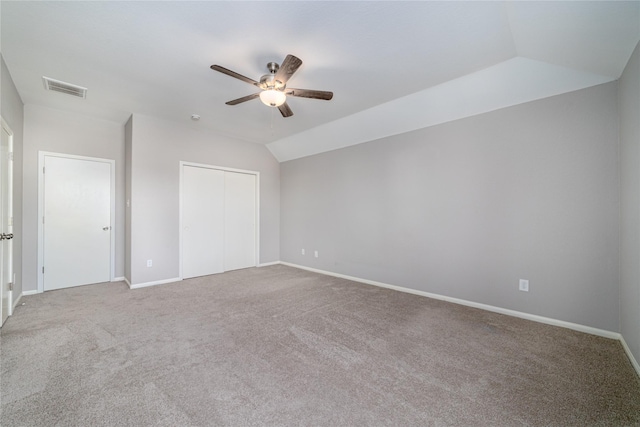 interior space featuring carpet, a closet, vaulted ceiling, and ceiling fan