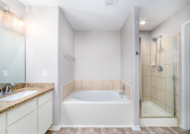 bathroom with vanity and independent shower and bath