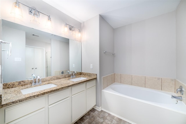 bathroom featuring a tub to relax in and vanity