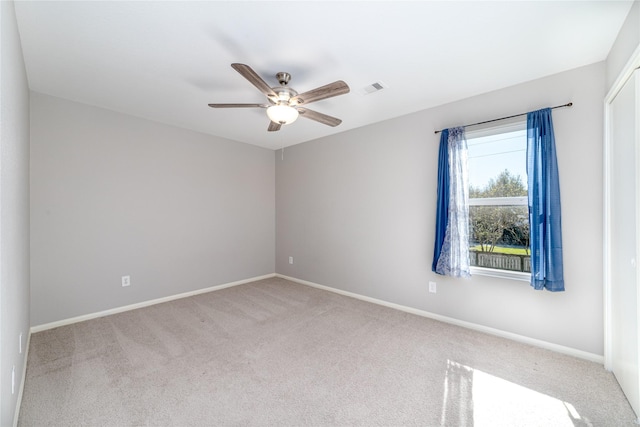 spare room featuring carpet and ceiling fan