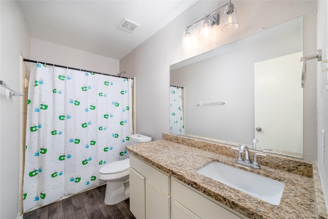 bathroom featuring vanity, curtained shower, toilet, and wood-type flooring