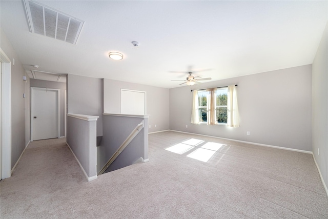 carpeted empty room featuring ceiling fan