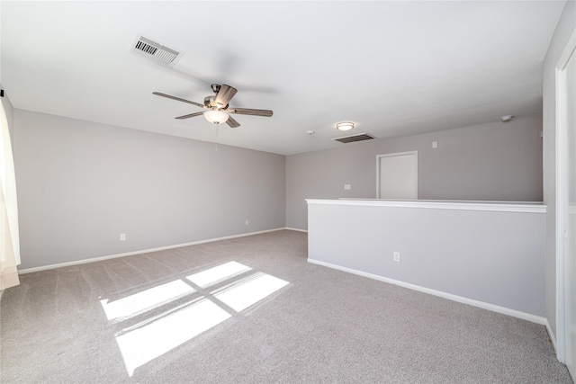 empty room featuring ceiling fan and light colored carpet