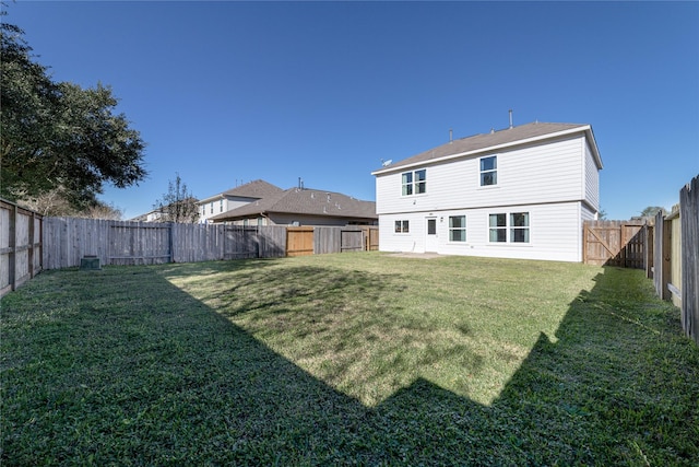 back of house featuring a yard