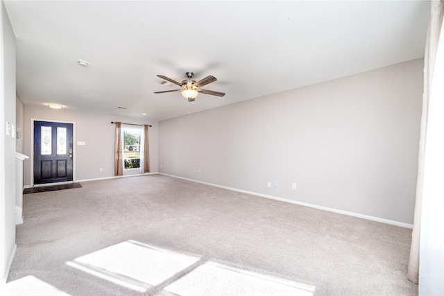 unfurnished living room with carpet flooring and ceiling fan