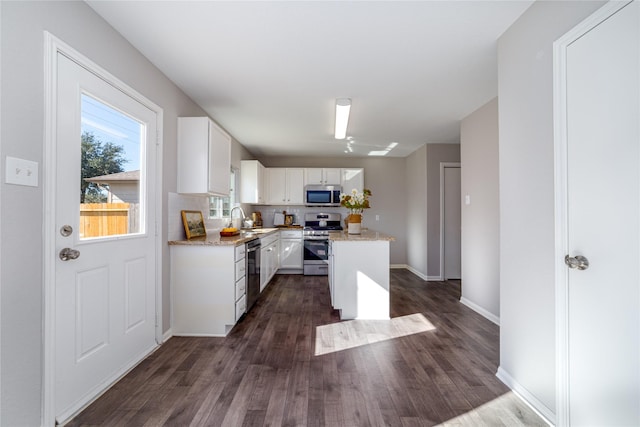 kitchen with sink, white cabinets, stainless steel appliances, and dark hardwood / wood-style floors