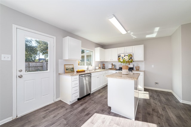 kitchen with white cabinets, a center island, stainless steel appliances, and dark hardwood / wood-style floors