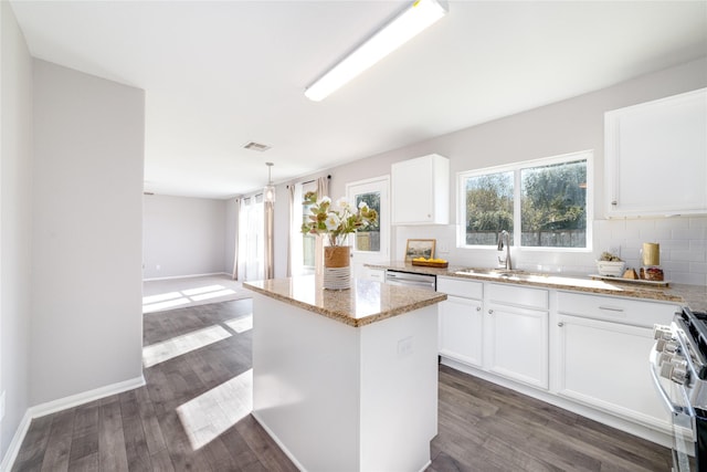 kitchen with white cabinetry, a center island, sink, stainless steel appliances, and dark hardwood / wood-style flooring