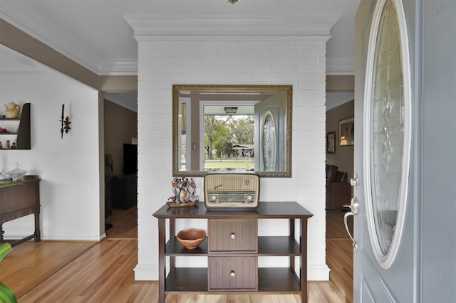 interior space featuring ornamental molding and light hardwood / wood-style flooring