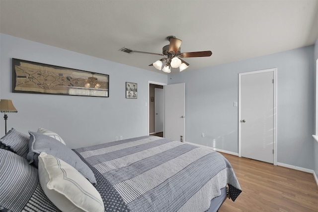 bedroom with light wood-type flooring and ceiling fan