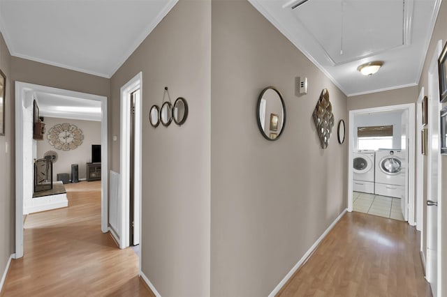 hall featuring light hardwood / wood-style floors, separate washer and dryer, and crown molding