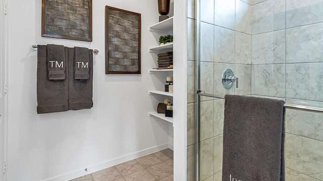 full bath with a shower stall and baseboards