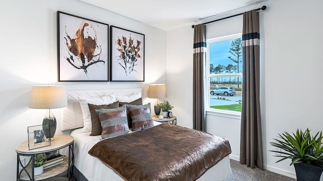 bedroom featuring carpet floors, multiple windows, and baseboards