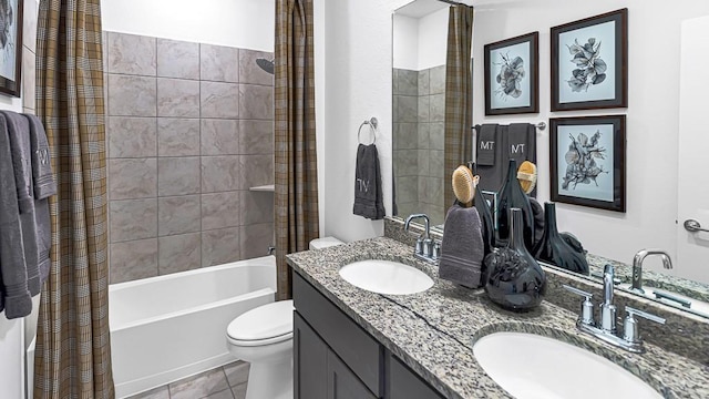 bathroom featuring toilet, double vanity, shower / bath combo, and a sink