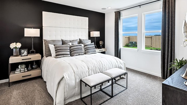 carpeted bedroom featuring baseboards