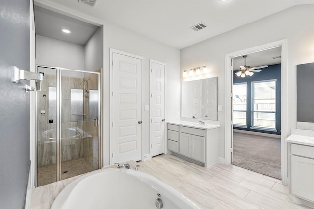 bathroom with vanity, separate shower and tub, and ceiling fan