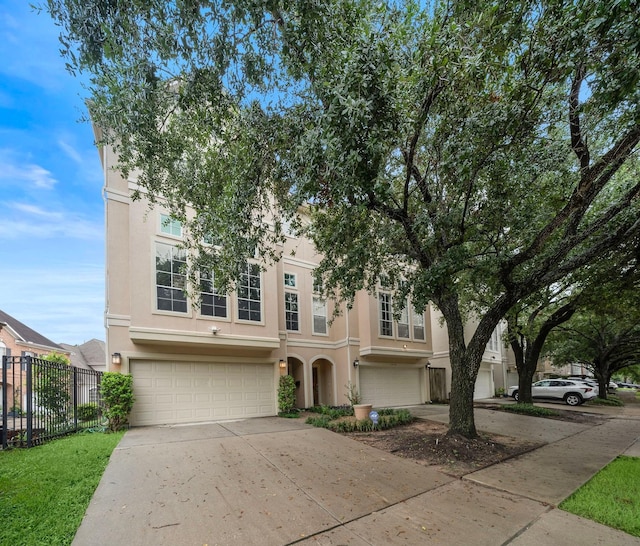 townhome / multi-family property with a garage