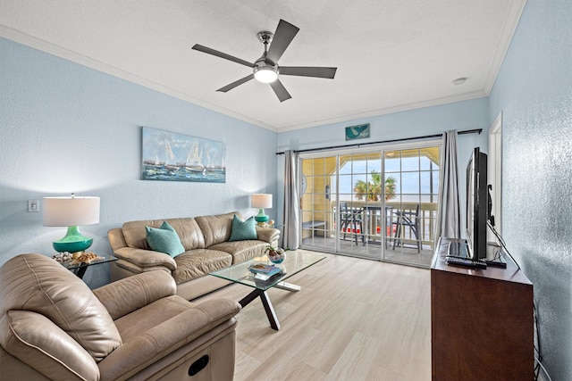 living room with crown molding, a textured ceiling, ceiling fan, and light wood-type flooring