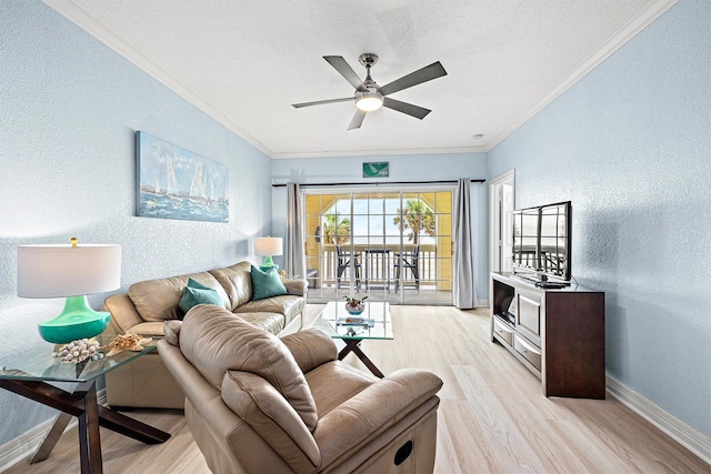 living room featuring ornamental molding, ceiling fan, a textured ceiling, and light hardwood / wood-style flooring