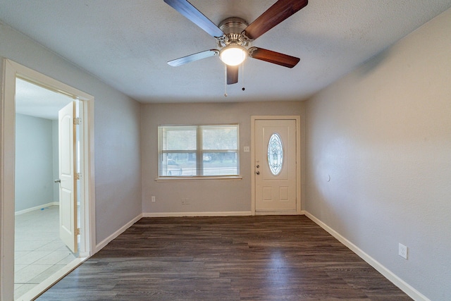 entrance foyer featuring a textured ceiling, dark hardwood / wood-style flooring, and ceiling fan