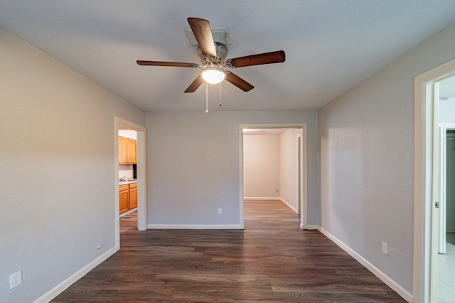 unfurnished room featuring ceiling fan and dark hardwood / wood-style flooring