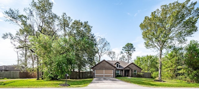 view of front of house with a garage and a front lawn