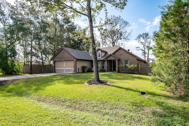 view of front of property with a front lawn and a garage