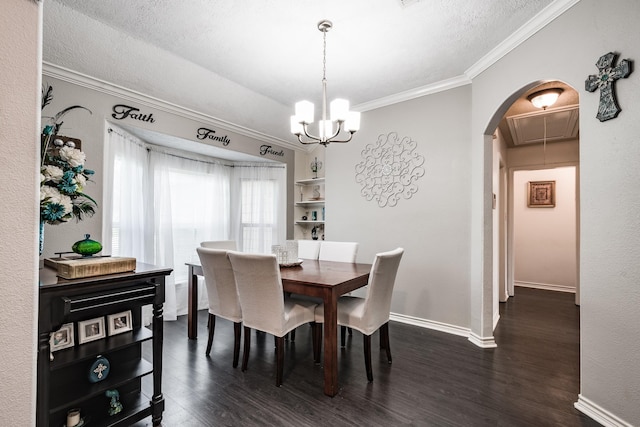 dining room with a chandelier, a textured ceiling, dark hardwood / wood-style flooring, and crown molding