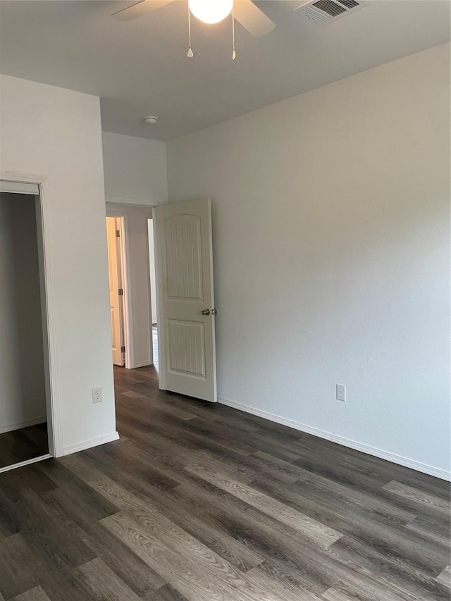 spare room with dark hardwood / wood-style floors and ceiling fan