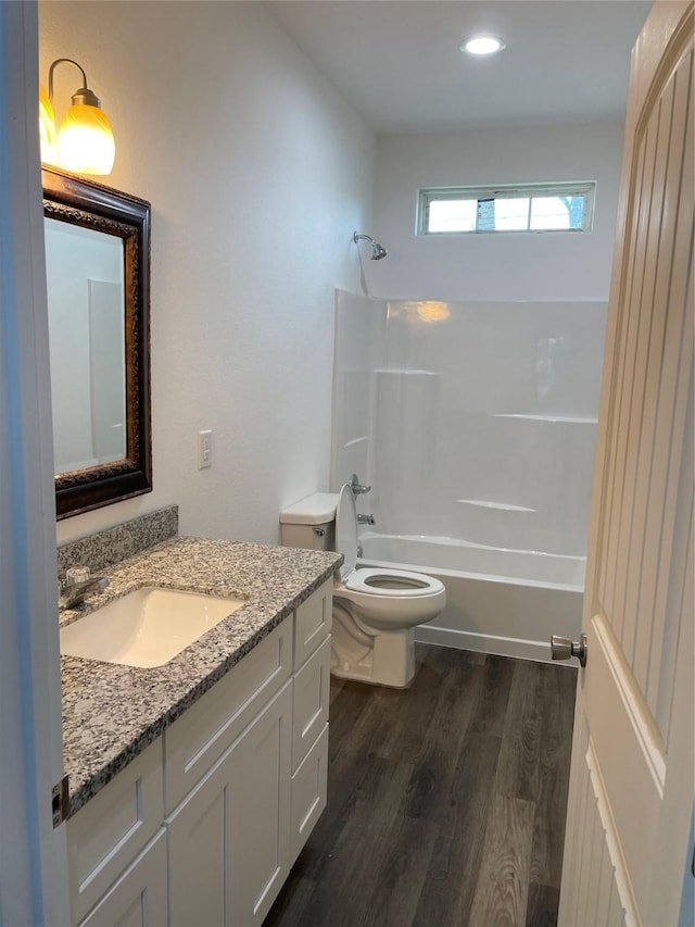 full bathroom with vanity, toilet, wood-type flooring, and shower / tub combination