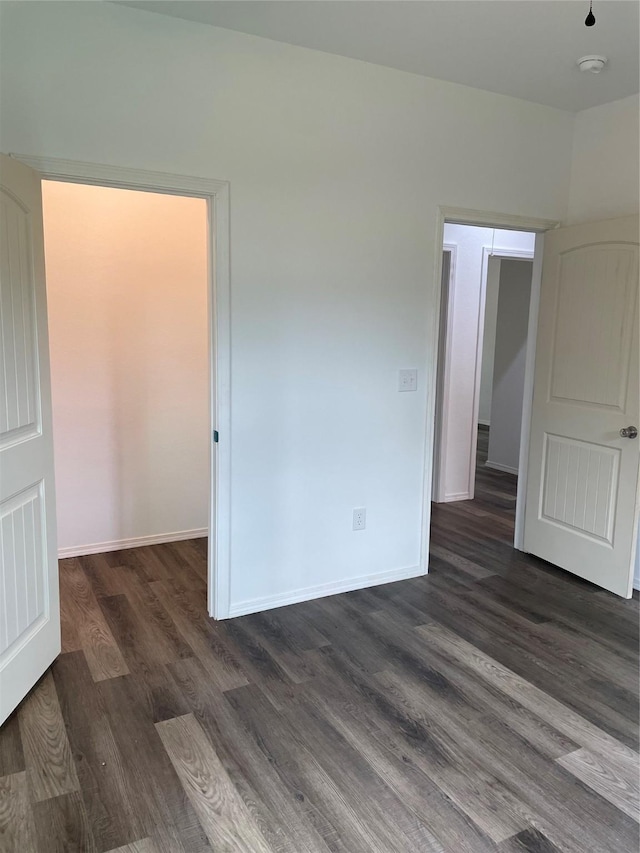 empty room featuring dark wood-type flooring