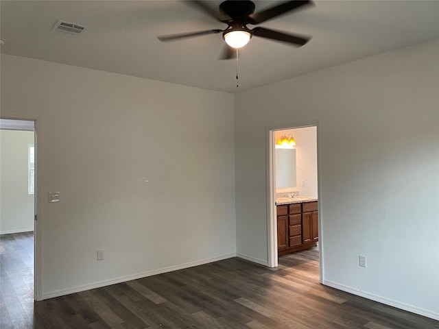 spare room with ceiling fan and dark hardwood / wood-style floors