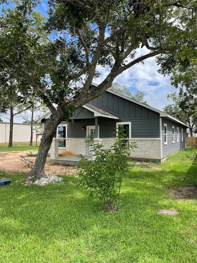 view of side of home featuring a lawn