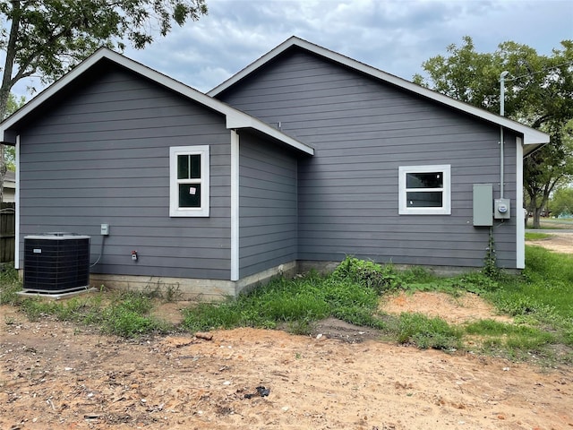 view of side of home featuring central AC unit