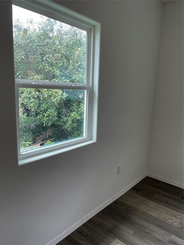 unfurnished room with dark hardwood / wood-style floors