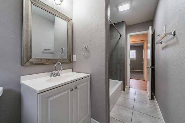 full bathroom featuring tile patterned floors, shower / bathtub combination, a textured ceiling, vanity, and toilet