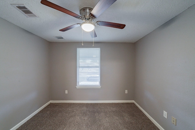 carpeted empty room with ceiling fan and a textured ceiling