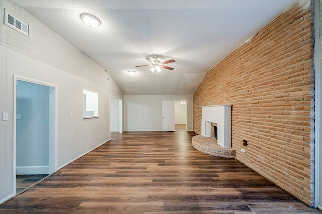 unfurnished living room with ceiling fan, dark hardwood / wood-style flooring, lofted ceiling, and a textured ceiling