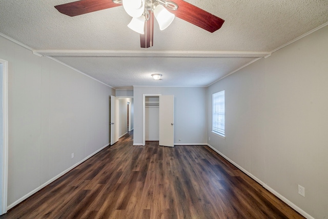 unfurnished bedroom featuring ceiling fan, dark hardwood / wood-style flooring, a textured ceiling, and ornamental molding