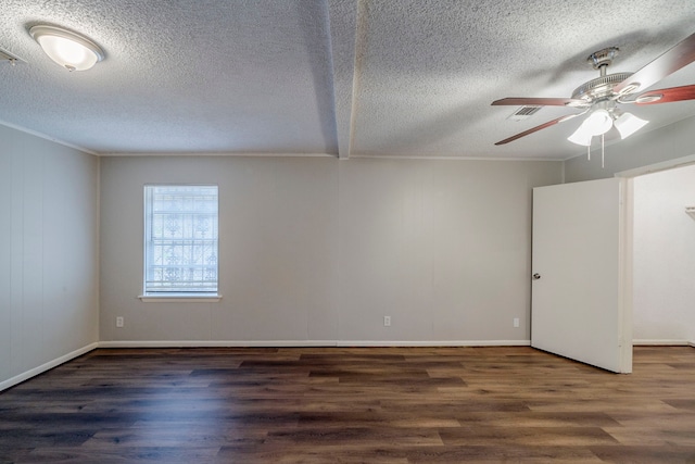 empty room with a textured ceiling, dark hardwood / wood-style flooring, ceiling fan, and ornamental molding